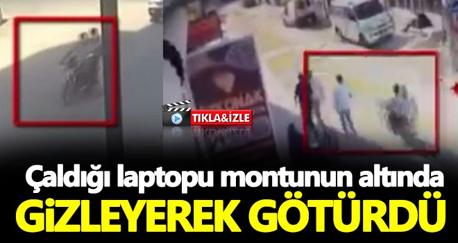 Çaldığı laptopu montunun altında gizleyerek götürdü